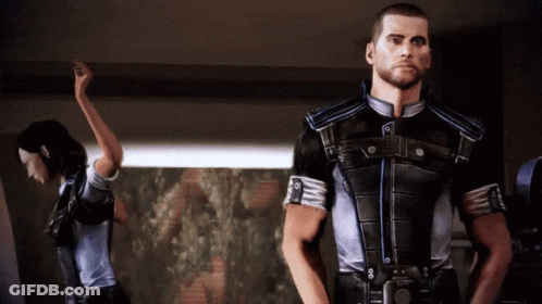 A Man And A Woman Are Standing In A Room GIF