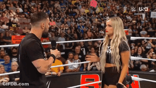 Man And Woman Talking In Wrestling Ring GIF