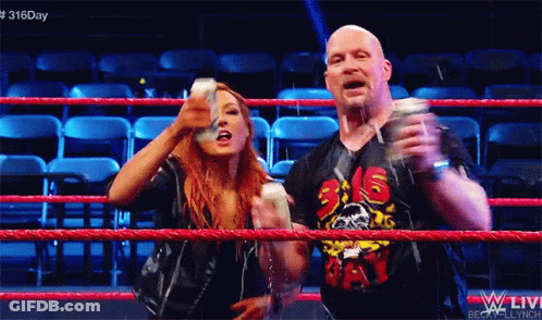 A Man And A Woman Are Standing In A Wrestling Ring With The Number 316 On Their Shirt GIF