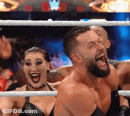 A Man And A Woman Are Standing In A Wrestling Ring With Their Mouths Wide Open GIF