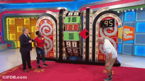 A Man And A Woman Are Standing In Front Of A Board That Says 95 GIF