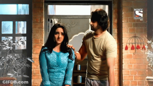 A Man And A Woman Are Standing In Front Of A Brick Wall With A Sony Television Hd Logo GIF