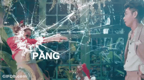 A Man And A Woman Are Standing In Front Of A Broken Glass Window With The Word Pang In The Corner GIF