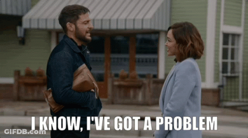 Man And Woman Standing In Front Of Building Saying I Know I Have A Problem GIF