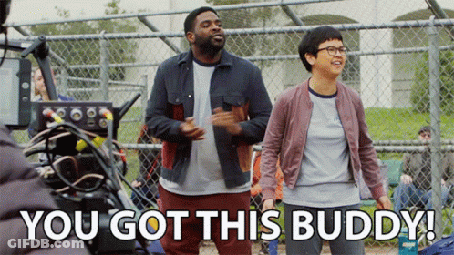 A Man And A Woman Are Standing In Front Of A Chain Link Fence With The Words You Got This Buddy Below Them GIF