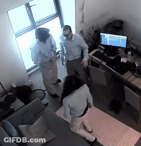 A Man And A Woman Are Standing In Front Of A Computer Monitor That Says ' Olympus ' On The Screen GIF