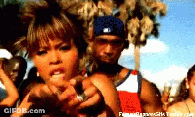 A Man And A Woman Are Standing In Front Of A Crowd . The Man Is Wearing A Nike Hat . GIF