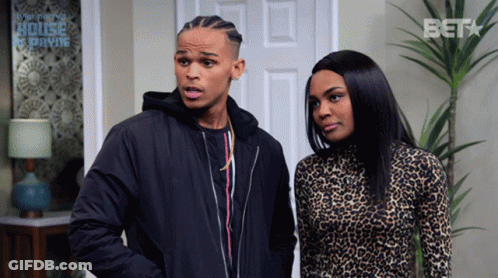 A Man And A Woman Are Standing In Front Of A Door That Says Bet GIF