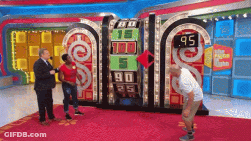 A Man And A Woman Are Standing In Front Of A Game Board That Says 80 15 100 5 90 25 And 95 GIF