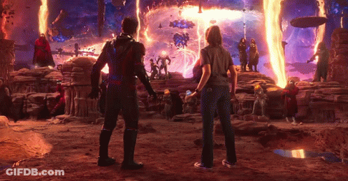 Man And Woman Standing In Front Of Fire GIF