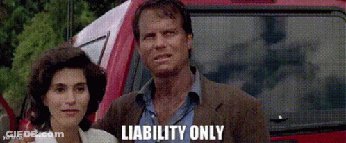 A Man And A Woman Are Standing In Front Of A Red Car With Liability Only Written On The Bottom Right GIF
