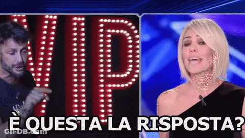 A Man And A Woman Are Standing In Front Of A Sign That Reads Vip GIF