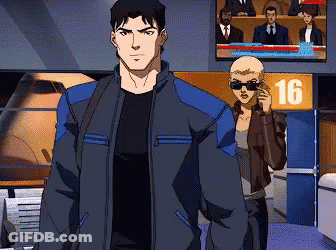 A Man And A Woman Are Standing In Front Of A Sign That Says 16 On It GIF
