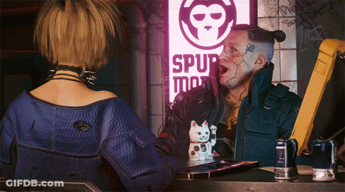 A Man And A Woman Are Standing In Front Of A Sign That Says Spur Man GIF