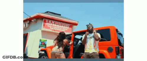 A Man And A Woman Are Standing In Front Of A Store Called D & M Discount GIF