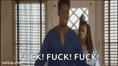 A Man And A Woman Are Standing In Front Of A Window . GIF