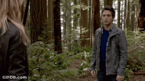 Man And Woman Standing In Woods GIF