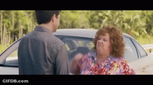 A Man And A Woman Are Standing Next To A Car And Having A Fight . GIF