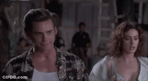A Man And A Woman Are Standing Next To Each Other . GIF