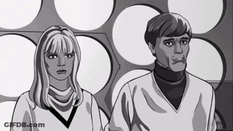 A Man And A Woman Are Standing Next To Each Other GIF