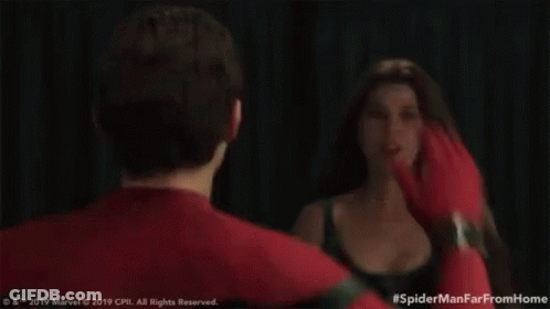 A Man And A Woman Are Standing Next To Each Other And Giving Each Other High Fives . GIF