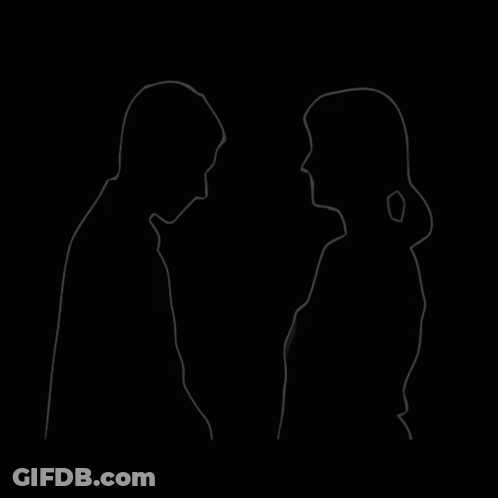 A Man And A Woman Are Standing Next To Each Other And Looking At Each Other . GIF