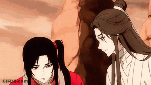 A Man And A Woman Are Standing Next To Each Other And Looking At Each Other . GIF