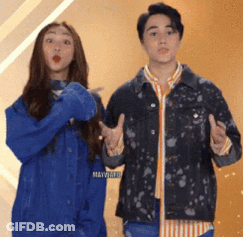 A Man And A Woman Are Standing Next To Each Other And Making Funny Faces GIF