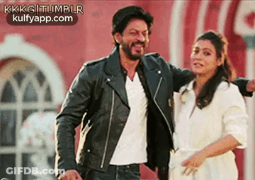 A Man And A Woman Are Standing Next To Each Other And Smiling . The Man Is Wearing A Leather Jacket . GIF