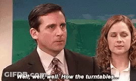 A Man And A Woman Are Standing Next To Each Other And Talking . GIF