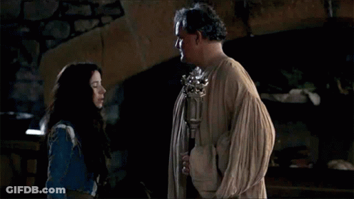 A Man And A Woman Are Standing Next To Each Other And Talking . GIF