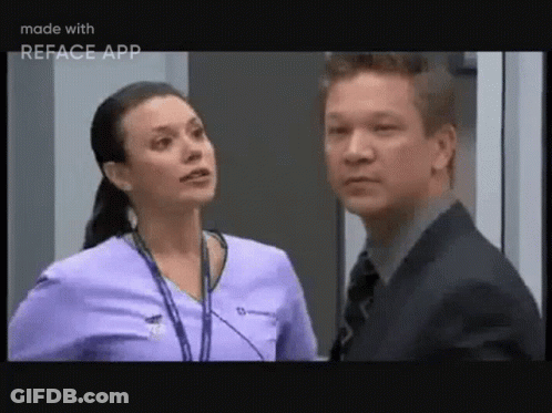 A Man And A Woman Are Standing Next To Each Other And Talking . GIF