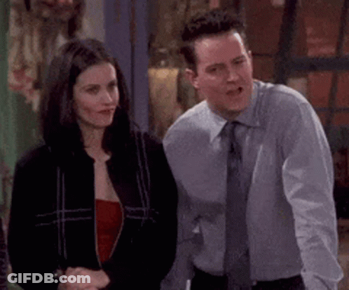 A Man And A Woman Are Standing Next To Each Other And Talking . GIF