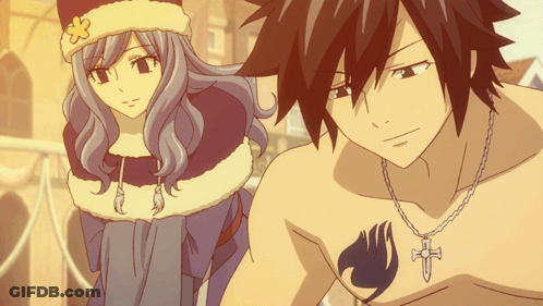 A Man And A Woman Are Standing Next To Each Other And The Man Has A Fairy Tail Tattoo On His Chest GIF