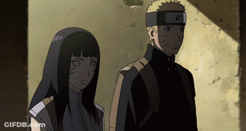 A Man And A Woman Are Standing Next To Each Other And The Man Has A Headband With The Letter G On It GIF