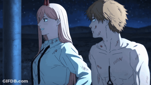 A Man And A Woman Are Standing Next To Each Other And The Man Has A Scar On His Chest GIF