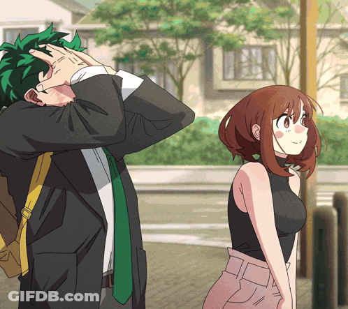 A Man And A Woman Are Standing Next To Each Other And The Man Is Covering His Face GIF