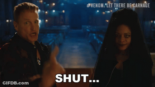 A Man And A Woman Are Standing Next To Each Other And The Man Is Pointing At The Woman And Says Your Mouth GIF