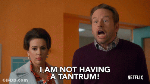A Man And A Woman Are Standing Next To Each Other And The Man Is Saying I Am Not Having A Tantrum GIF
