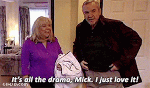 A Man And A Woman Are Standing Next To Each Other And The Man Is Saying It 'S All The Drama GIF