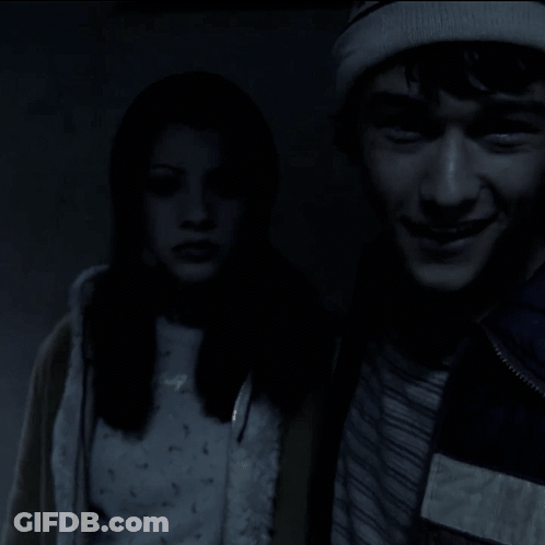 A Man And A Woman Are Standing Next To Each Other And The Man Is Smiling GIF