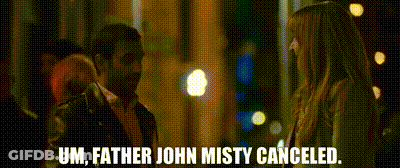 A Man And A Woman Are Standing Next To Each Other And The Man Is Talking To The Woman . GIF