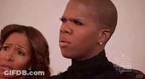 A Man And A Woman Are Standing Next To Each Other And The Man Is Wearing A Black Shirt GIF
