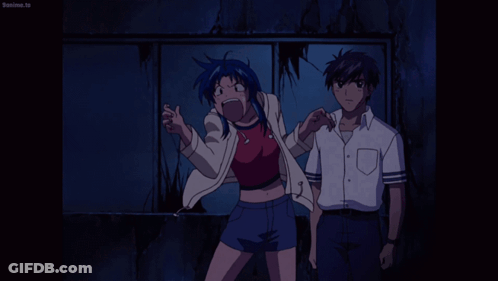 A Man And A Woman Are Standing Next To Each Other And The Man 'S Shirt Says Beanime.tv On It GIF