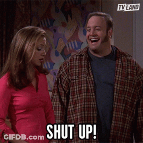 A Man And A Woman Are Standing Next To Each Other And The Man Says Shut Up GIF