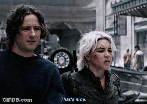 A Man And A Woman Are Standing Next To Each Other And The Man Says That 'S Nice GIF