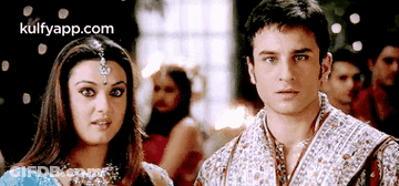 A Man And A Woman Are Standing Next To Each Other And The Website Kulfyapp.com Is Visible In The Corner GIF