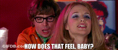 A Man And A Woman Are Standing Next To Each Other And The Woman Is Asking The Man How Does That Feel Baby . GIF