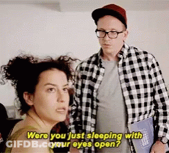 A Man And A Woman Are Standing Next To Each Other And The Woman Is Asking The Man If He Is Sleeping With Her Eyes Open GIF