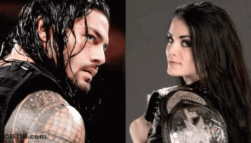 A Man And A Woman Are Standing Next To Each Other And The Woman Is Holding A Championship Belt GIF